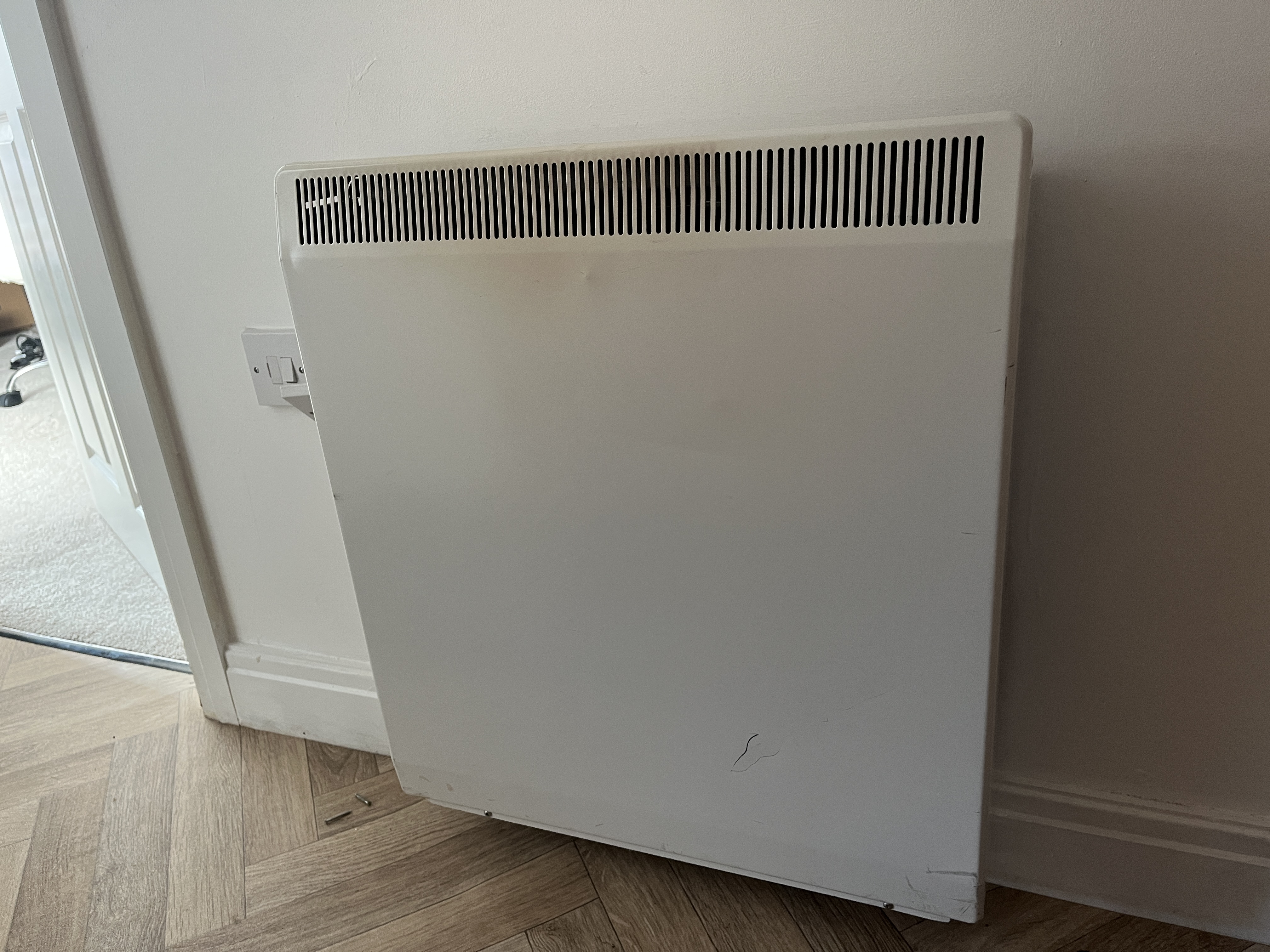 Old night storage heater on wall